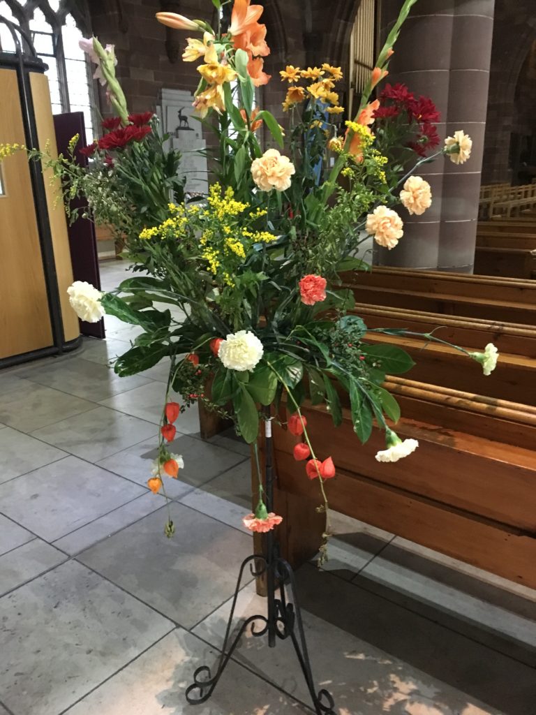 A photo of a harvest flower display at St Martin in the Bullring church